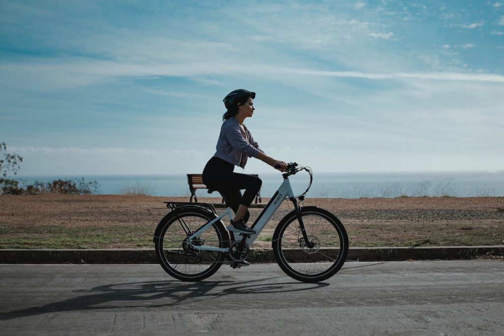 a woman on an ebike on a road 